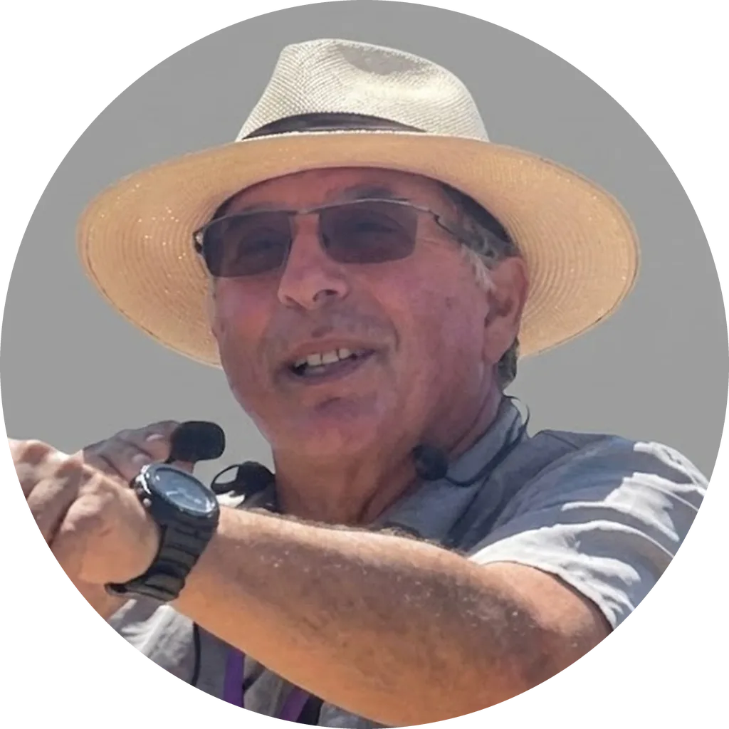 Pepe Heiblum, licensed tour guide from Kibbutz Mefalsim, wearing a straw hat and guiding a tour